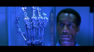 Miles Dyson gazes at the Terminator's hand