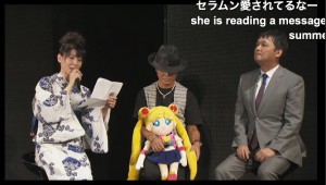 Kotono Mitsuishi, Toru Foruya and Osa-P reading a letter from series creator Naoko Takeuchi at Sailor Moon 20th anniversary event
